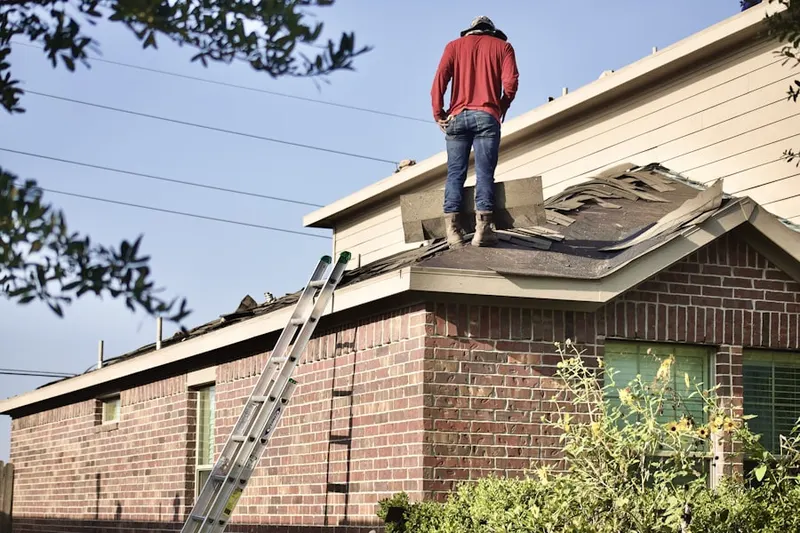 Professional roofer working on a residential roof in Summerwoods